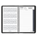 A spiral bound black At-A-Glance daily appointment book open to a black and white page with numbers.