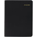 An At-A-Glance black appointment book with gold lettering.