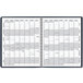 A navy spiral bound At-A-Glance monthly planner with numbers on it.