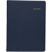 An At-A-Glance navy monthly planner with gold text on the cover.