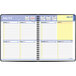 A spiral bound black At-A-Glance planner with a calendar and yellow accents.