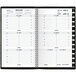 A black spiral bound At-A-Glance weekly appointment book with a calendar.