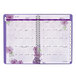 A spiral bound At-A-Glance planner with purple flowers on the cover.