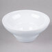 A white Elite Global Solutions melamine bowl on a gray surface.