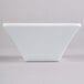 A white square Elite Global Solutions melamine bowl on a white surface.