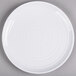 A white Elite Global Solutions round melamine plate with a spiral design.