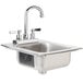 A stainless steel Advance Tabco drop-in sink with two faucets.