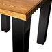 A square wooden table with a BFM Seating black I-beam table base.