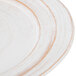 A close up of an Elite Global Solutions Della Terra melamine plate with an off white irregular edge and brown rim.