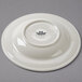 A white china soup bowl with an embossed white swirl rim.