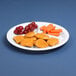 A white Elite Global Solutions 3-compartment melamine plate with chicken nuggets, grapes, and carrots.