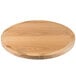 A BFM Seating natural ash veneer round table top on a wooden table.