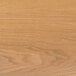 A close-up of a BFM Seating natural ash veneer table top with wood grain.