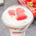 A WNA Comet low dome lid on a cup of strawberries.