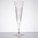 A clear plastic champagne flute with a long stem.