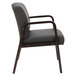 A black leather Alera reception arm chair with wooden legs.
