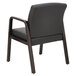 A black Alera reception arm chair with wooden legs.