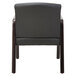 A black leather Alera reception arm chair with espresso wood frame.