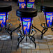 A group of University of Florida LED bar stools with blue and orange vinyl seats on a metal table.