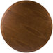 A BFM Seating round wooden table top with a dark wood finish.