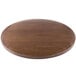 A BFM Seating round wooden table top with an autumn ash veneer.