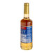 A Torani Butter Rum flavoring syrup 750mL glass bottle with a blue label.