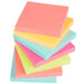 A close up of a stack of 3M Post-It notes with different colors.