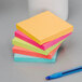 A stack of 3M Cape Town Collection Post-It notes with a pen on a white surface.