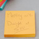 A yellow 3M Post-It note with the words "Meeting with Dawn at 5:00" handwritten on it.
