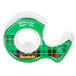 A green and white 3-pack of 3M Scotch transparent tape with a green scotch tape dispenser.