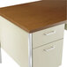 A cherry and putty steel desk with wood surfaces and double pedestal drawers.