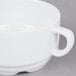 A stackable white porcelain soup bowl with a handle.