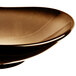 A black porcelain bowl with a brown rim.