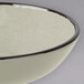A white Elite Global Solutions round crackle bowl with a black rim.