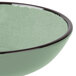 A green Elite Global Solutions Hemlock Crackle Bowl with a black rim.