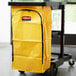 A yellow Rubbermaid high capacity vinyl bag on a cart.