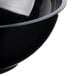 A close up of a black Fineline high profile plastic catering bowl with a white rim.