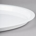 A white Fineline plastic catering tray with a high rim on a gray surface.