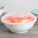 A white Fineline high profile plastic bowl filled with carrots and salad.