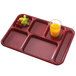 A red Cambro compartment tray with grapes and a glass of juice.
