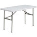 A Flash Furniture white rectangular folding table with metal legs.
