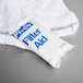 A white bag with blue text that reads "Pitco Filter Powder" on a white towel.