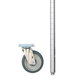 A metal pole with a silver aluminum Metro truck dolly frame and wheel.