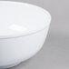 A white Thunder Group melamine pho noodle bowl on a gray surface.