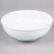 A white Thunder Group melamine pho noodle bowl with a white rim on a gray surface.