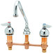 An Advance Tabco heavy-duty deck-mount faucet with two handles and a swing nozzle.