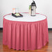 A table with a red Snap Drape table skirt on it.