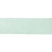 A close-up of a roll of mint green streamer paper.