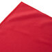 A red shirred pleat table skirt with velcro clips.