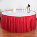 A table with a red Snap Drape table skirt on it.